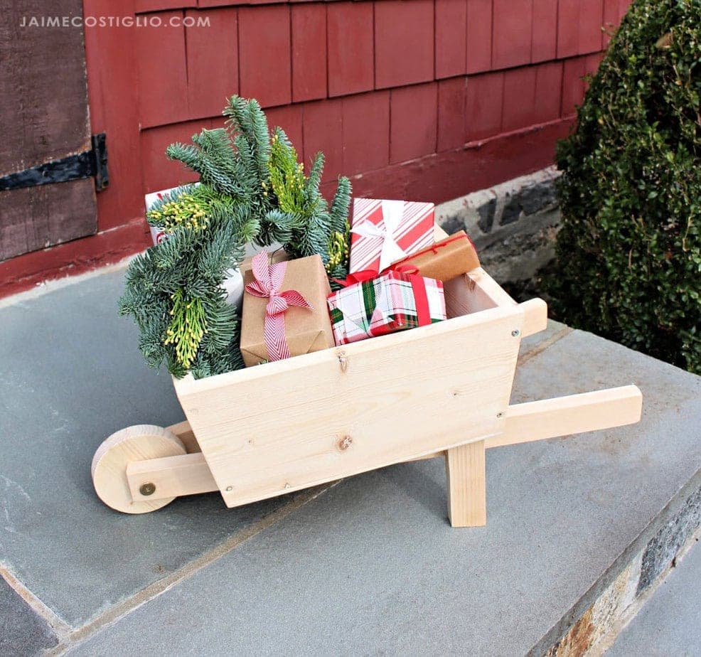 Small wooden toy wheelbarrow with a working front wheel