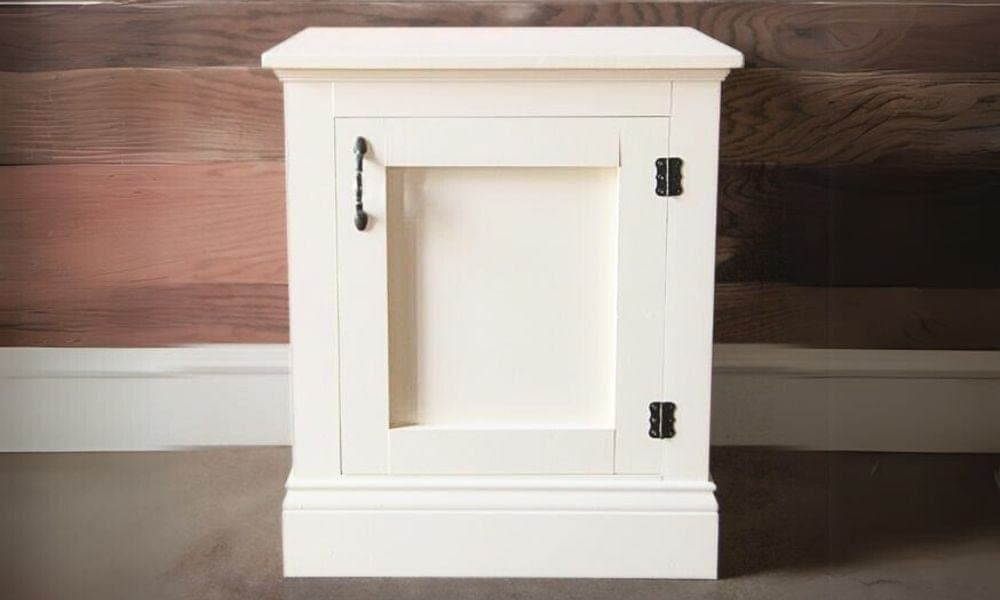 Single-door cabinet nightstand with recessed side panels and base moulding