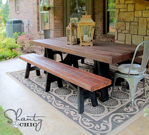 Long outdoor bench on splayed sawhorse-style legs