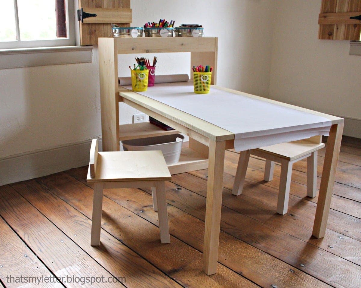 Child's art center with a low pine bookshelf and an attached craft table