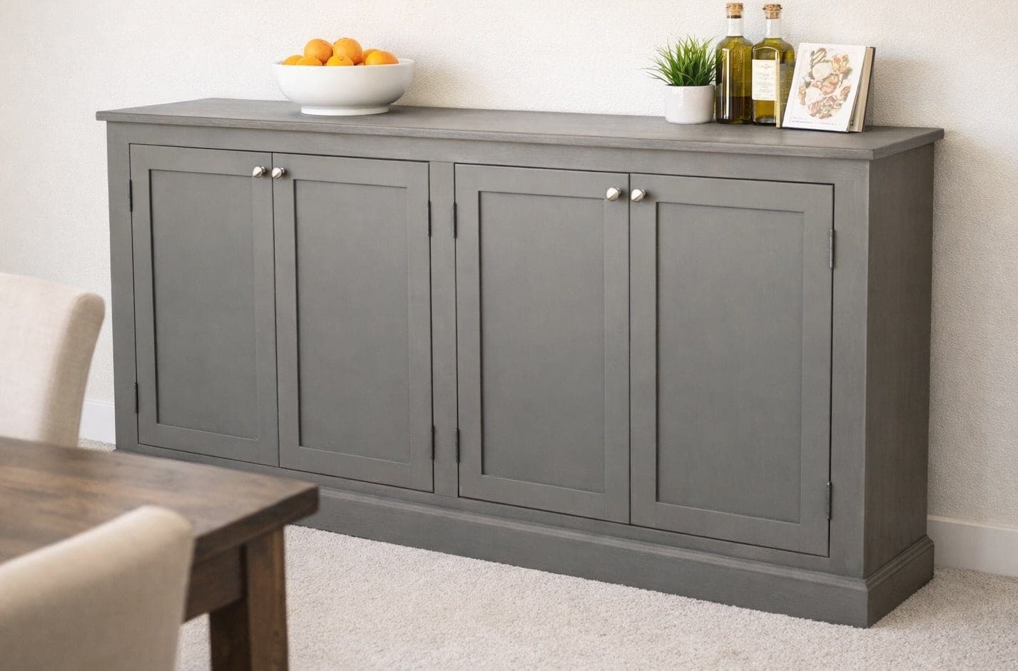 A wide cabinet console table with a face frame and four inset doors