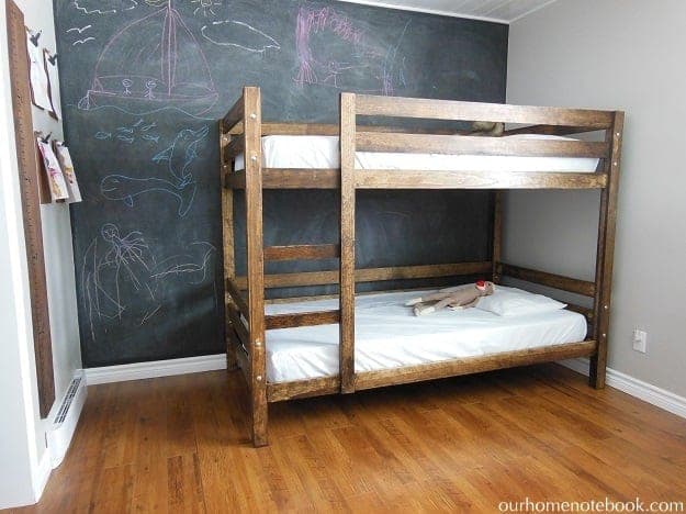 Classic white bunk beds with built-in ladder and trimmed posts