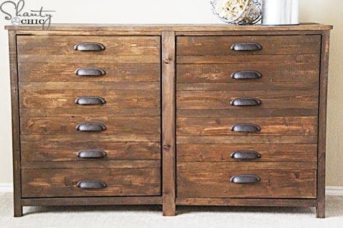 Printer's console table with a bank of decorative drawer faces
