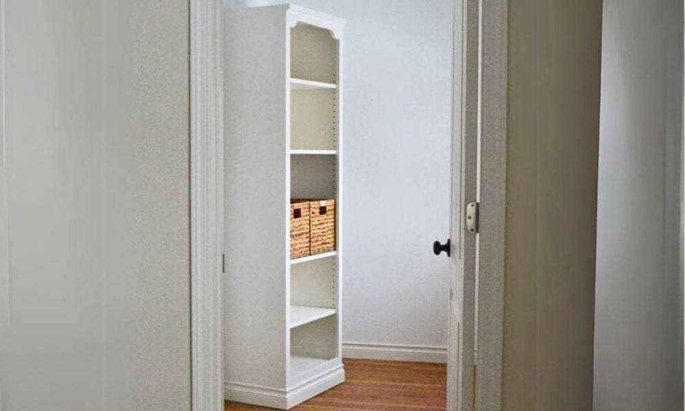 A tall closet storage tower with adjustable plywood shelves and a face frame