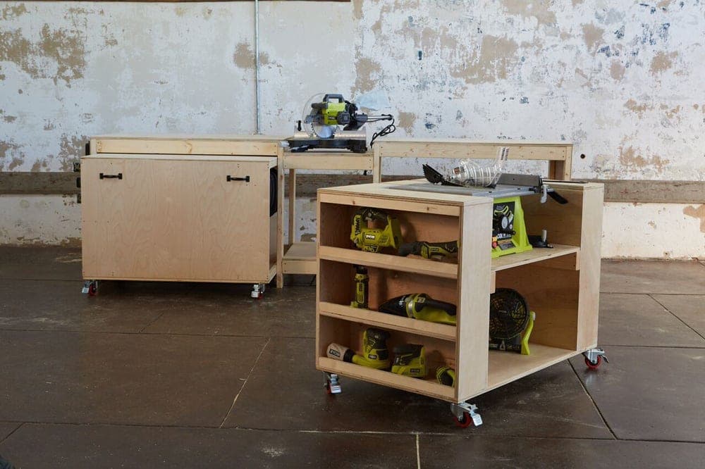 Garage workbench with recessed miter saw and rolling tool carts stored underneath