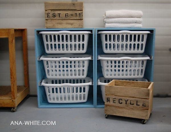 Painted plywood tower holding three laundry baskets as sliding drawers