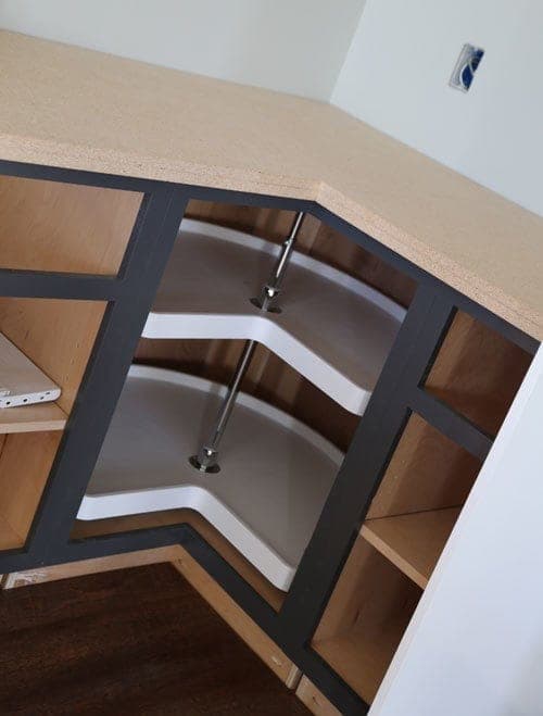 Square corner base kitchen cabinet with a face frame and a single overlay door