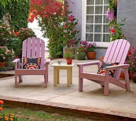 A small slatted outdoor Adirondack-style side table
