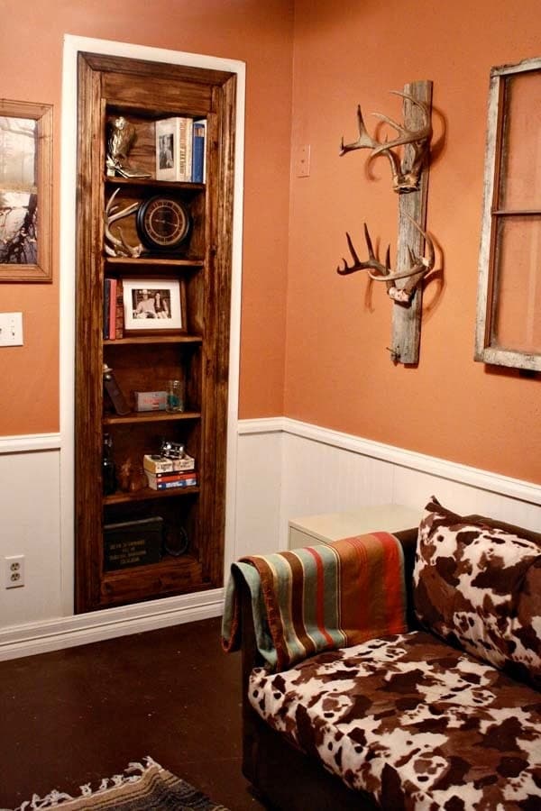 Bookshelf built as a hidden door, swinging open in a doorway