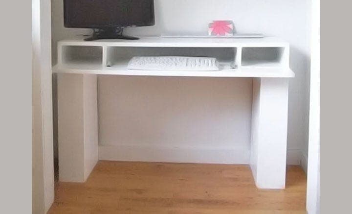 Chunky wood console desk with flip-down keyboard tray and hidden leg storage