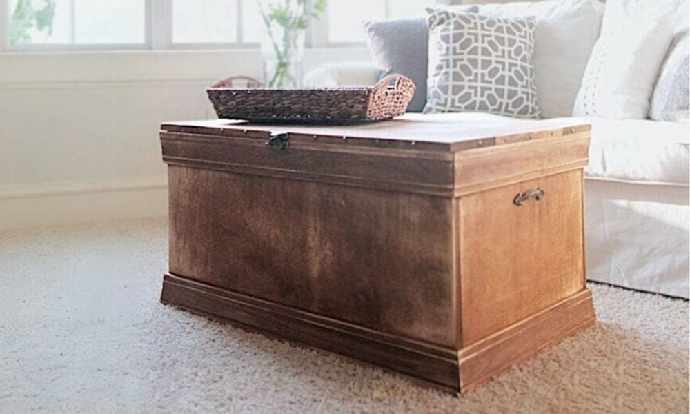 Wood storage trunk with mitered base moulding and a planked lid
