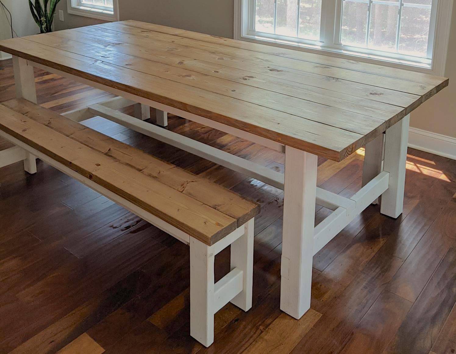 Farmhouse dining table with thick laminated legs and breadboard-end plank top