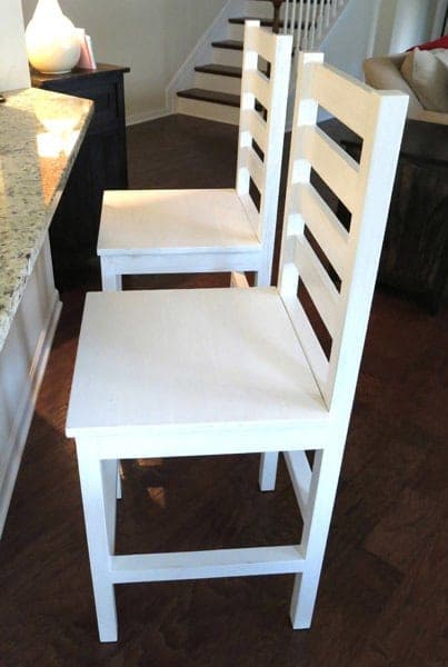 Counter-height bar stool with a slatted seat and a ladder back
