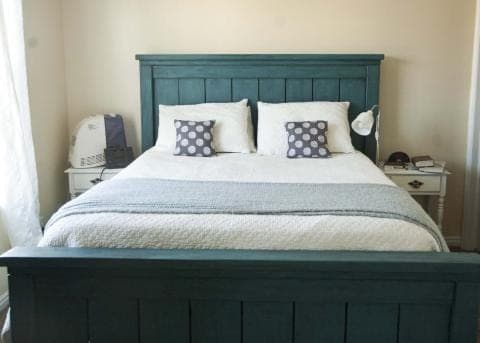 California king farmhouse bed with planked headboard and footboard