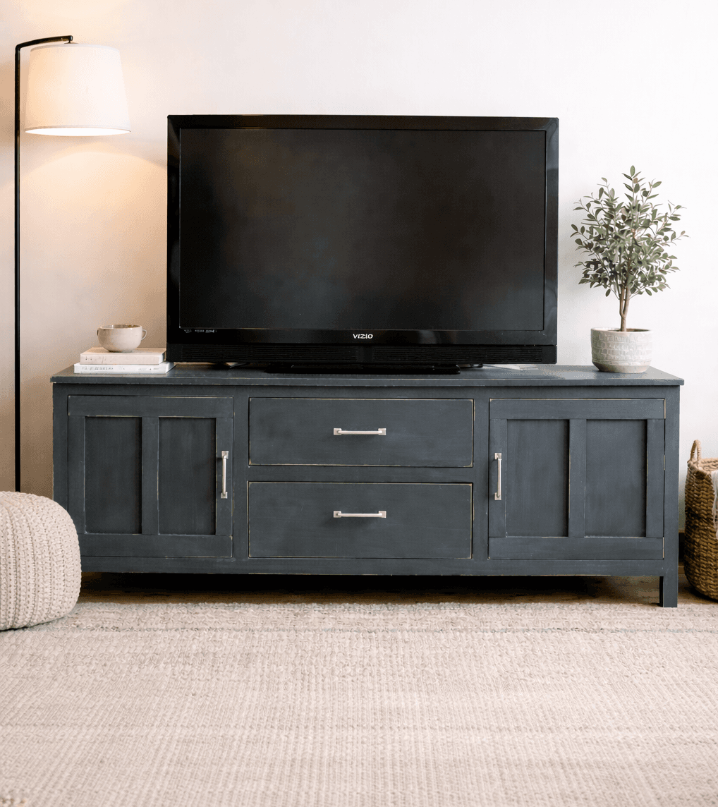 A media console with two drawers and two board-and-batten doors on chunky legs