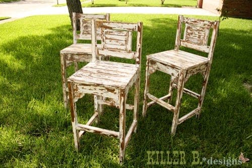 Vintage-style wooden bar stool with a slatted seat and low backrest