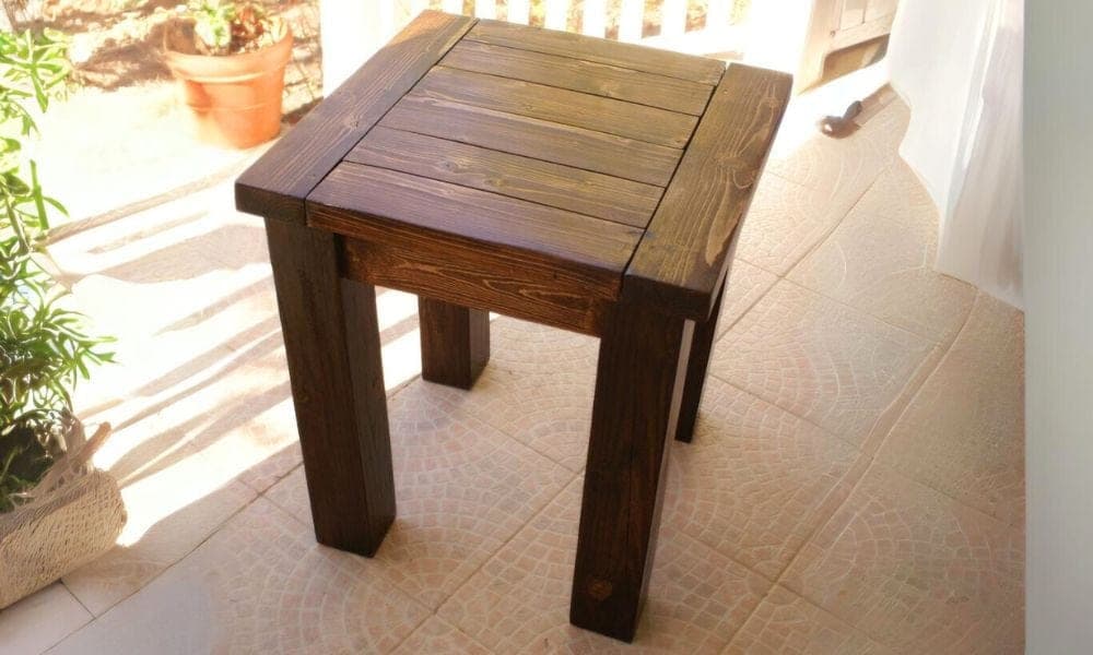 A small side table with chunky 4x4 legs and a breadboard-ended 2x6 top