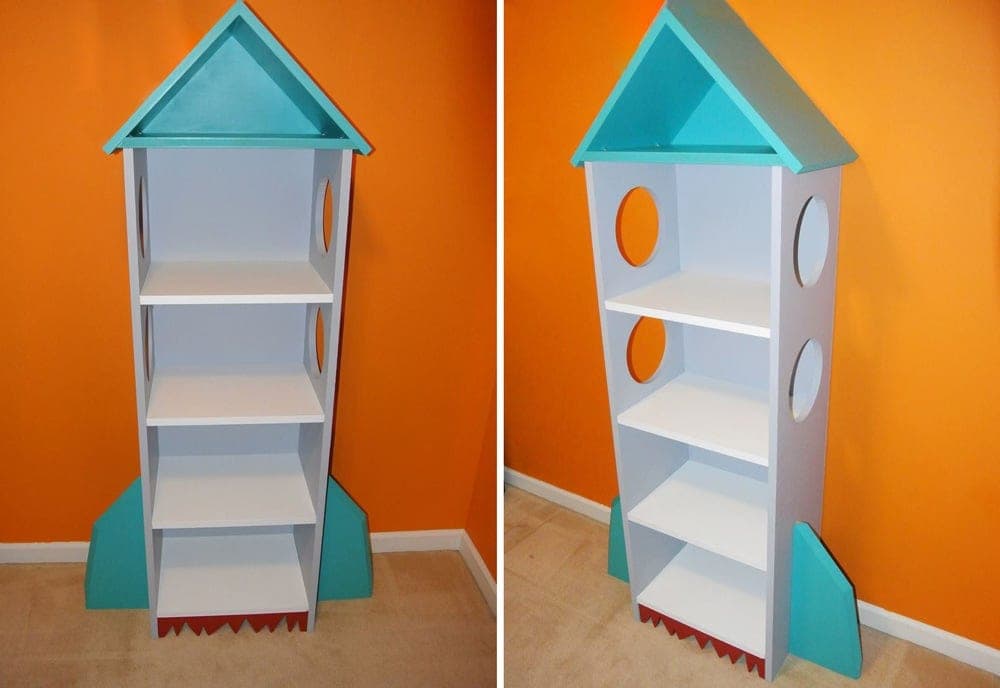 Kids' bookcase shaped like a rocket ship with fins and a nose-cone roof