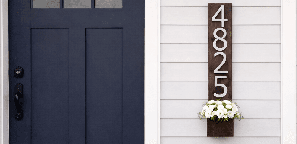 Vertical cedar wall planter with house numbers mounted above a small flower box