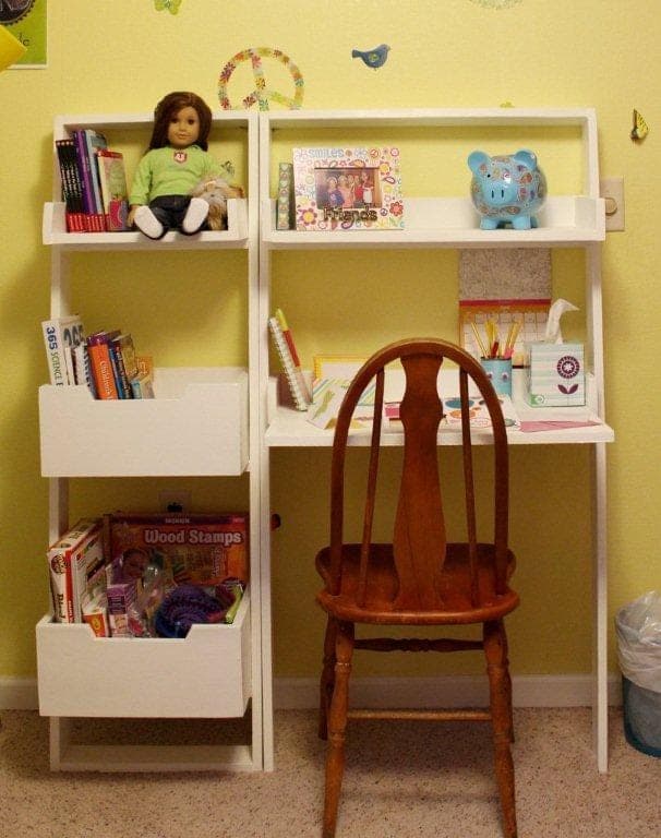 Wall-mounted leaning bookshelf with a 10-degree angled frame and three staggered storage boxes