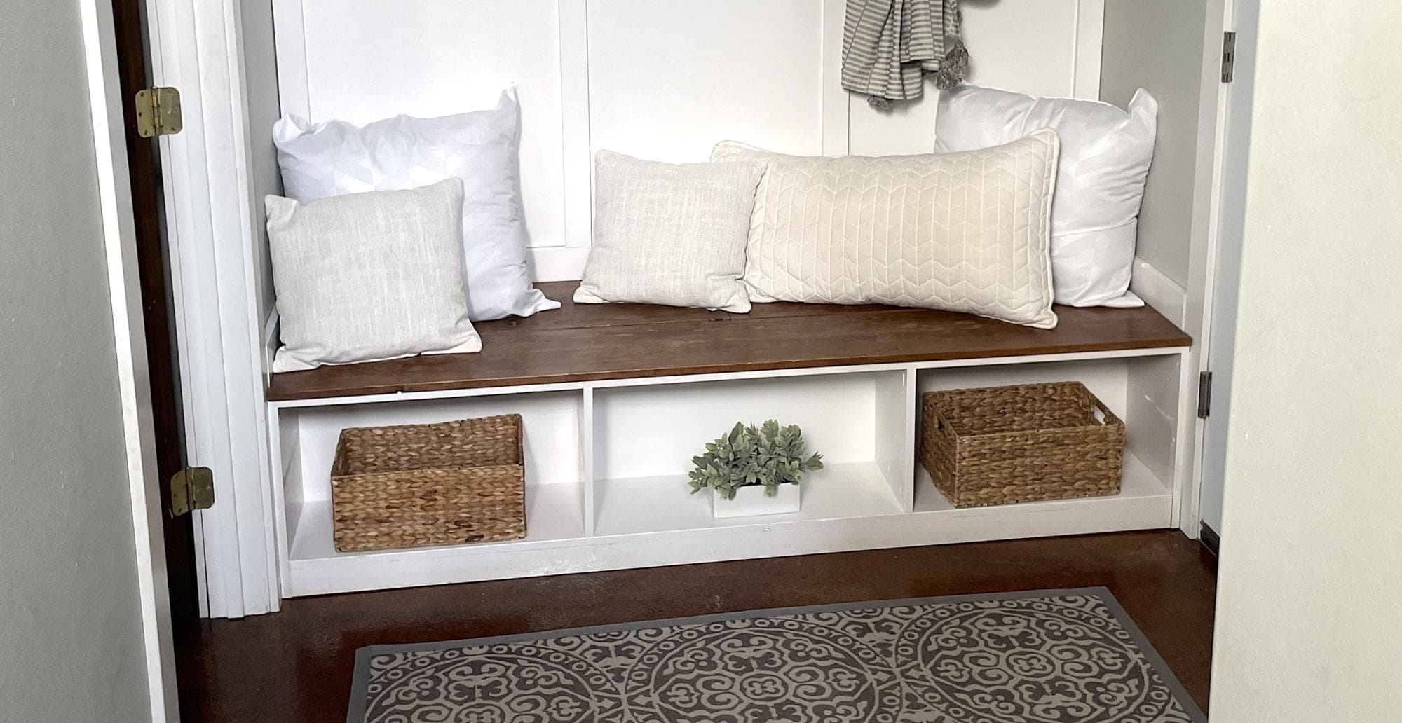Entryway shoe bench with hidden divided shelving behind the seat