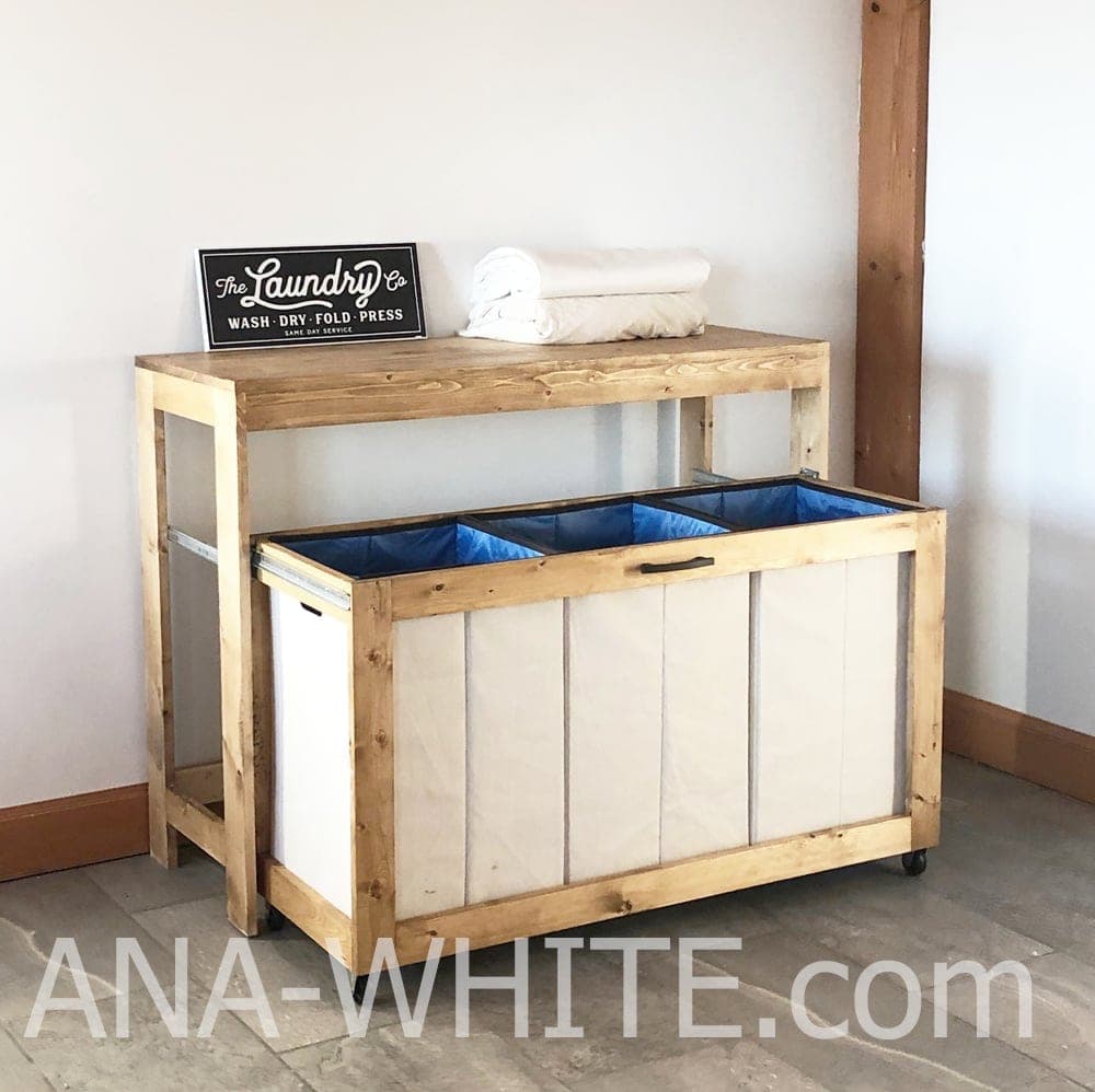 Laundry sorting cart that rolls out from under a tabletop