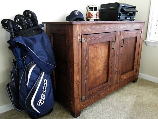 Two-door office storage cabinet with frame-and-panel sides and tapered feet