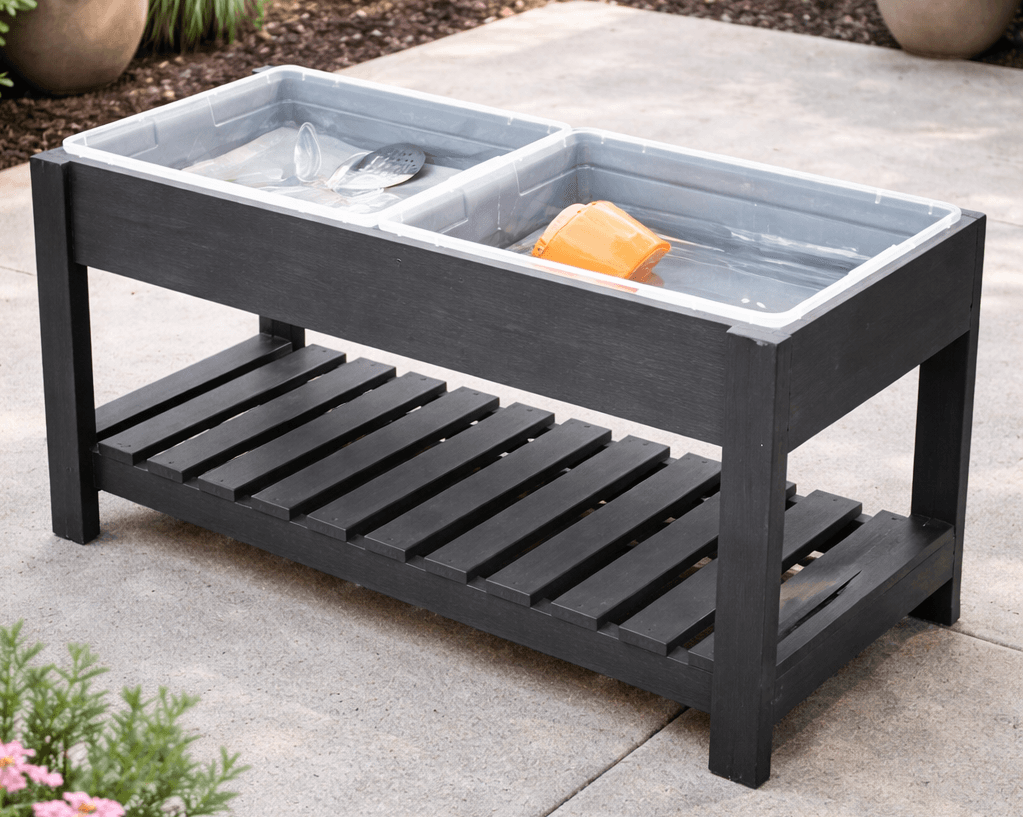 Kid-height wooden play table with two inset plastic tubs for sand and water