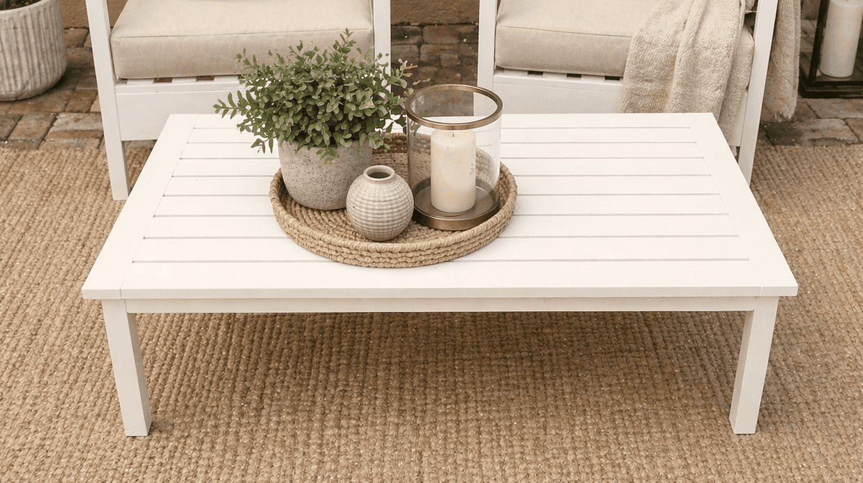 A planked outdoor coffee table with breadboard ends on a simple 2x2 leg frame