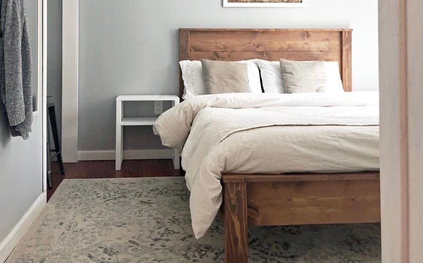 Wood panel bed with horizontal plank headboard and low footboard
