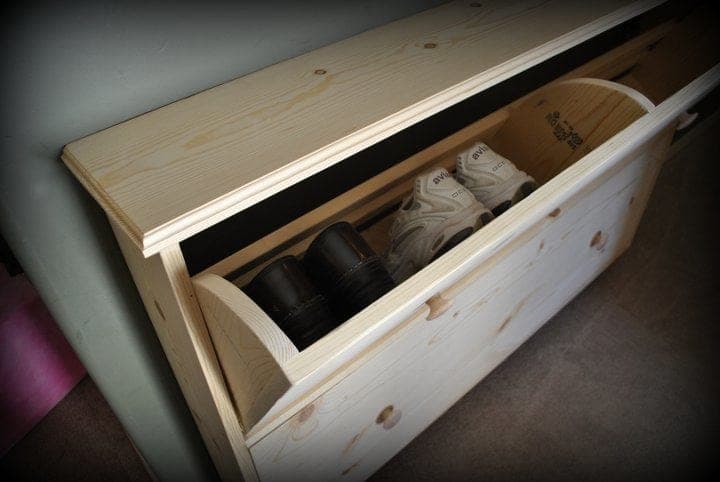 Slim shoe dresser with tilt-out storage bins in a hallway