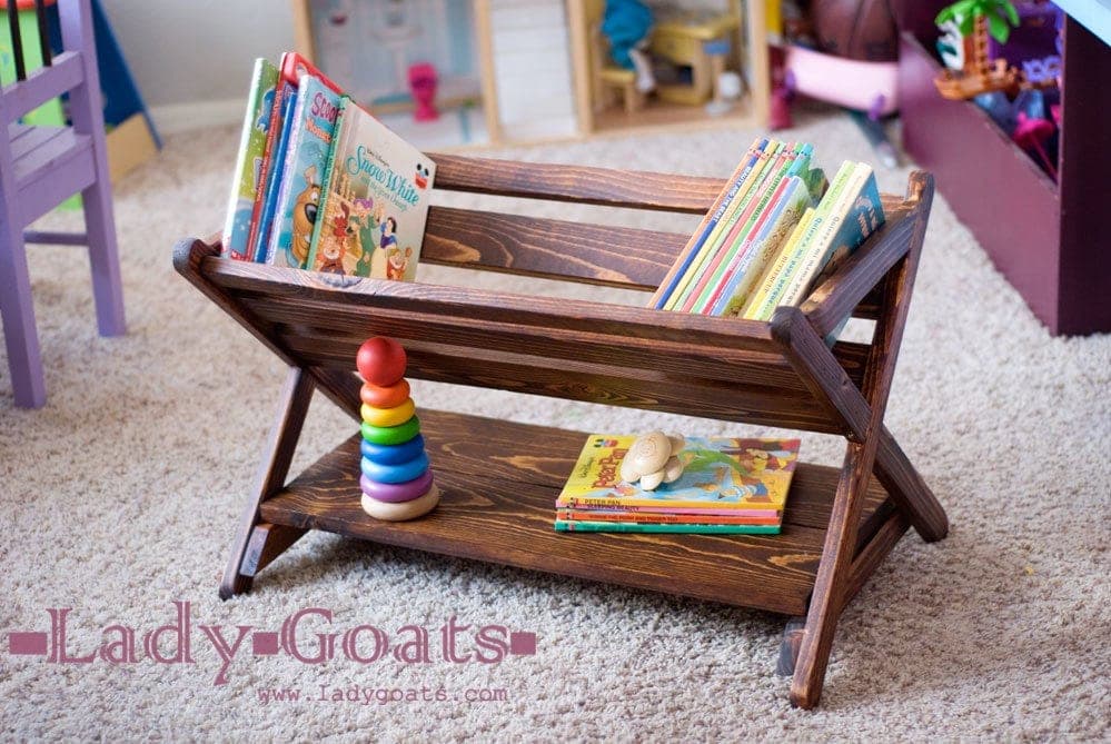 A small two-tier book caddy with mitered X-shaped end panels