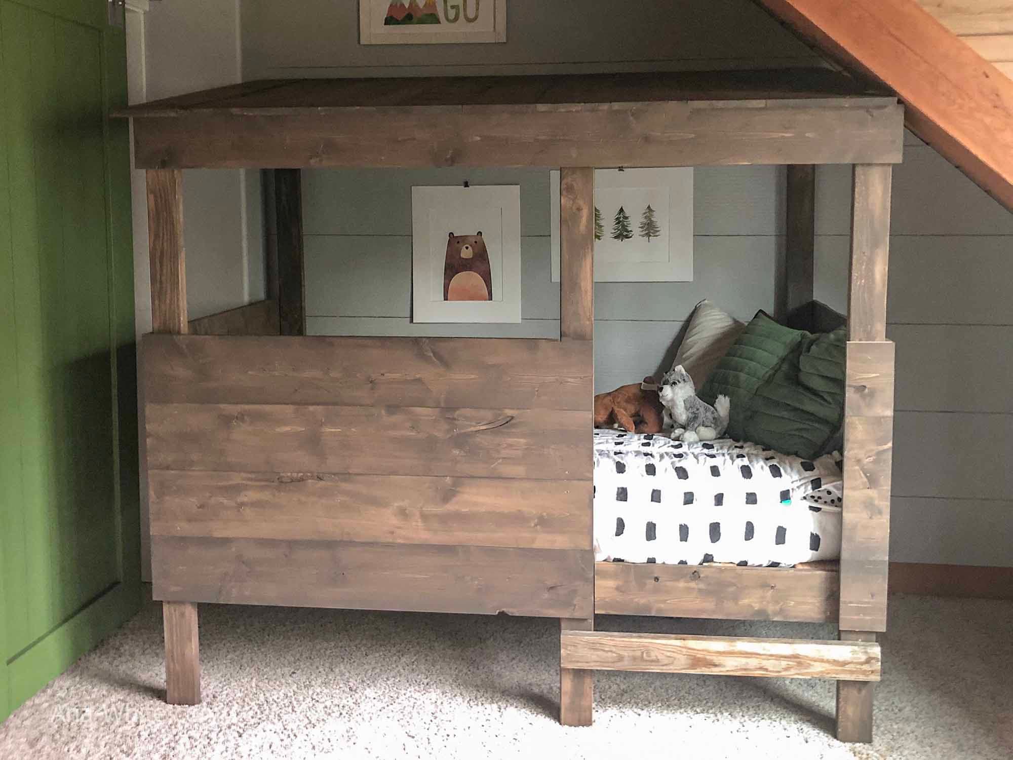 Twin bed built to look like a peaked-roof treehouse cabin