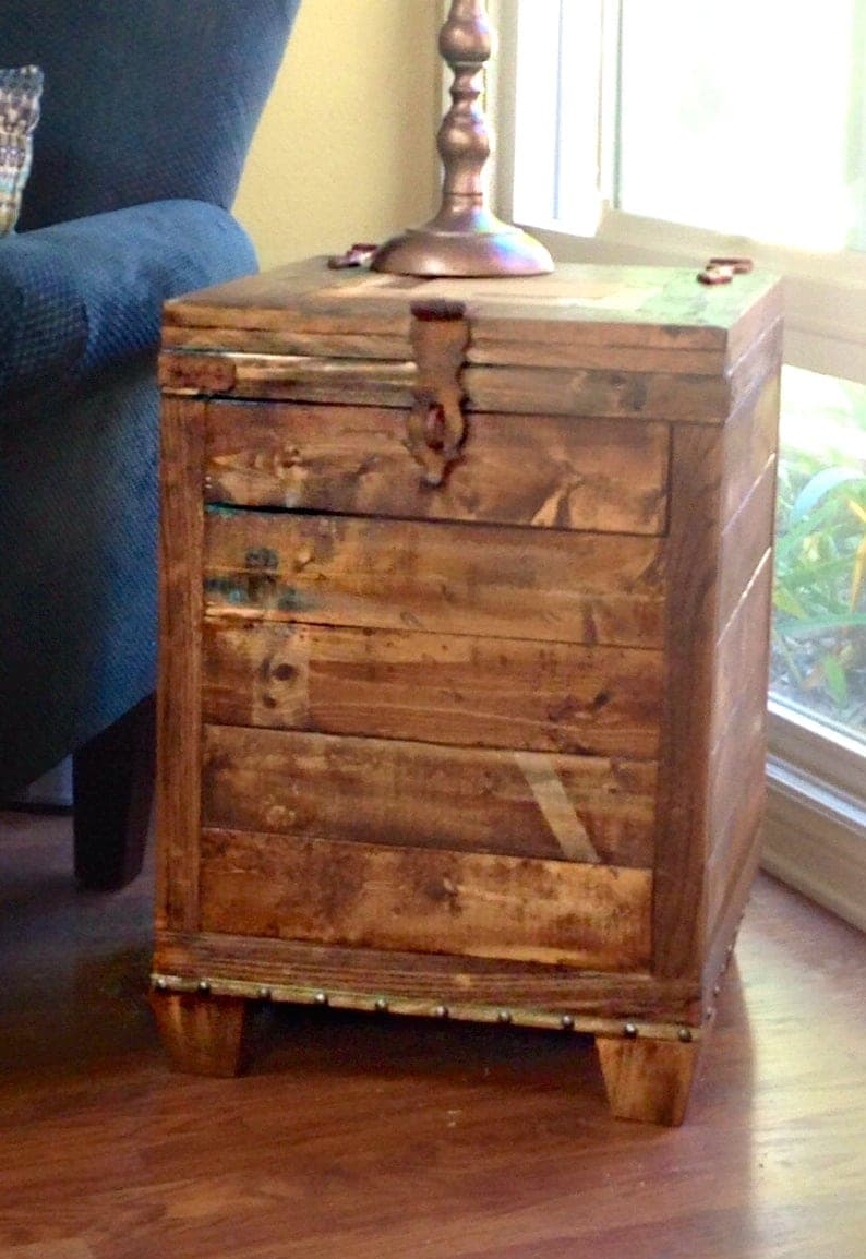Slat-paneled trunk side table with bun feet and a hinged lid