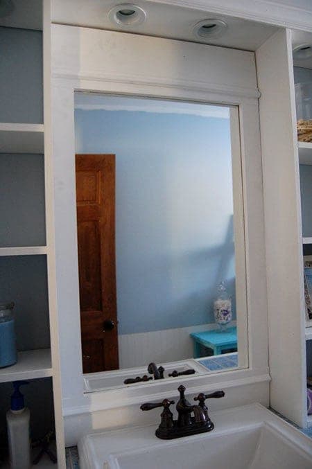 Wood-framed bathroom vanity mirror with an optional shelf