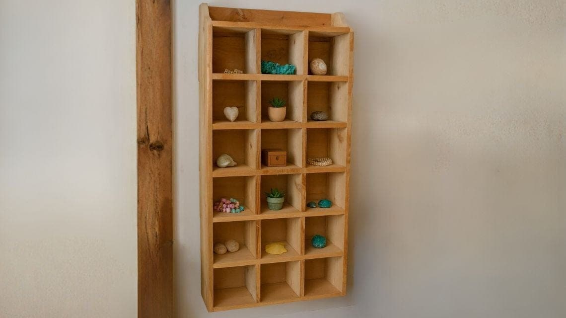 Wall shelf with notched grid of display cubbies