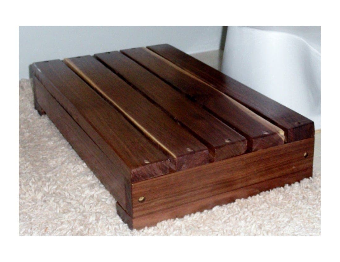 Small slatted wooden step stool for a bathroom