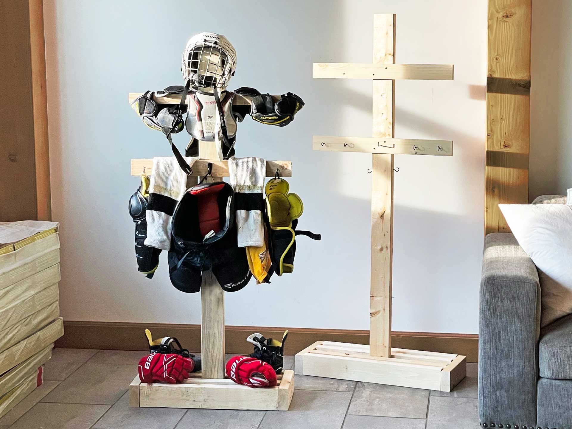 Freestanding wooden rack holding hockey gear to dry