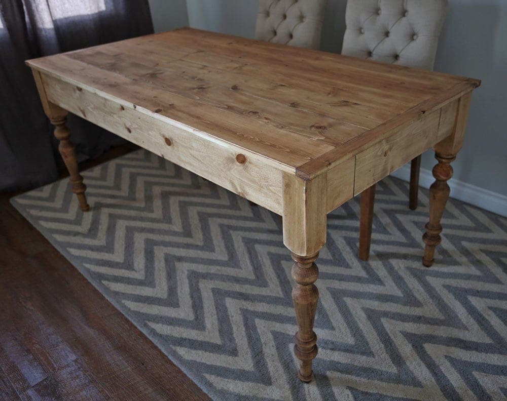 Small farmhouse dining table with turned legs and a planked pine top