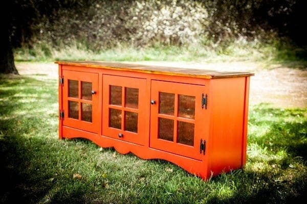 Farmhouse media console with a slatted-grid door design and pine face frame