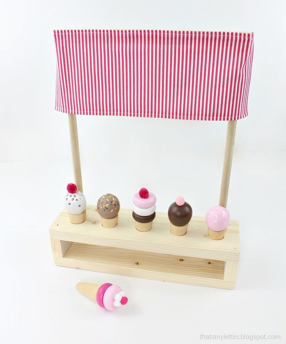 Small tabletop pretend-play ice cream stand with wood cone and scoop pieces