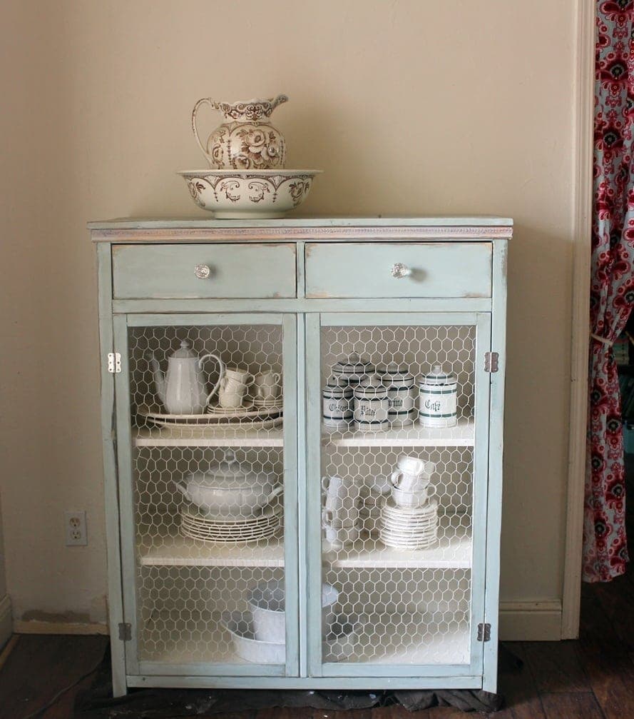 Tall linen cabinet with two panel doors over two drawers