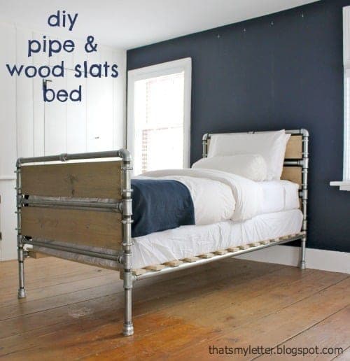 Industrial bed frame of galvanized pipe with wood slats on pipe hangers