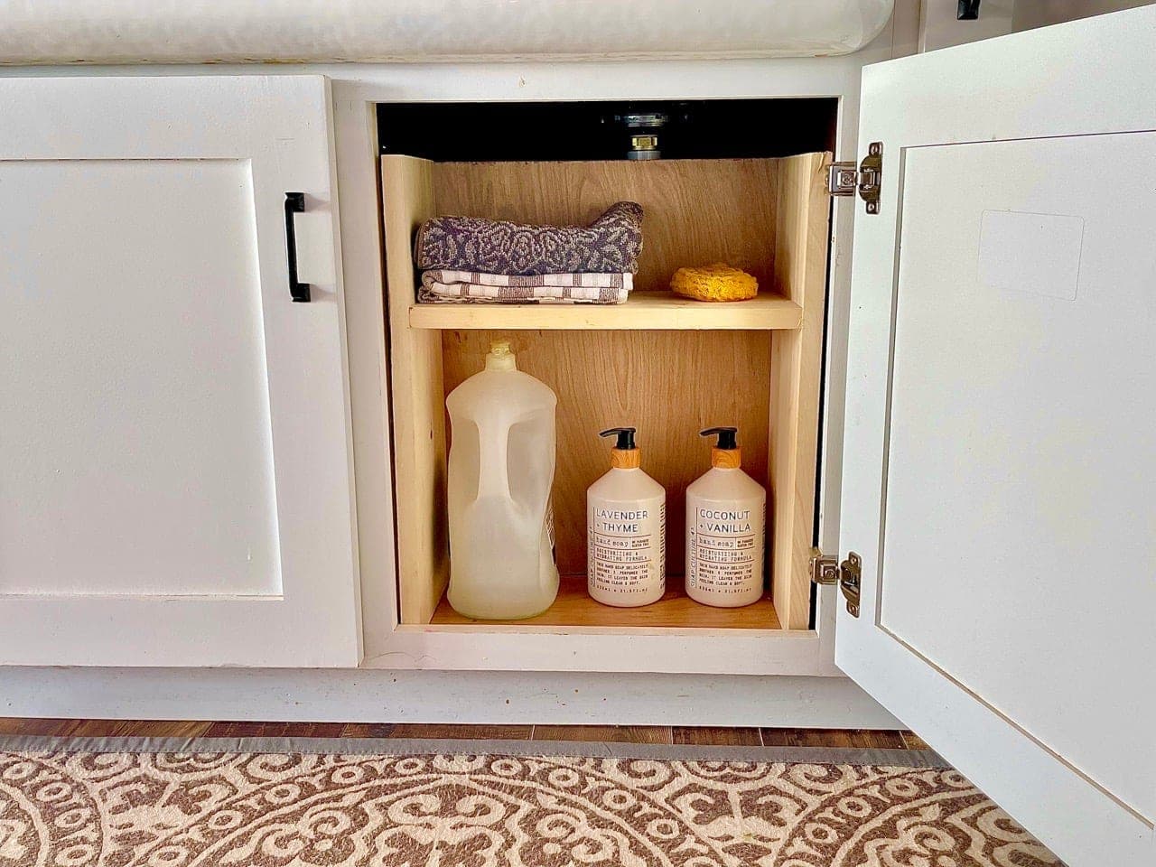 A simple wood shelf organizer built to fit under a kitchen sink