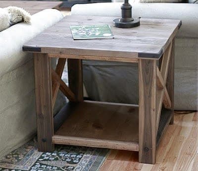 Rustic X-braced end table with decorative bolt hardware
