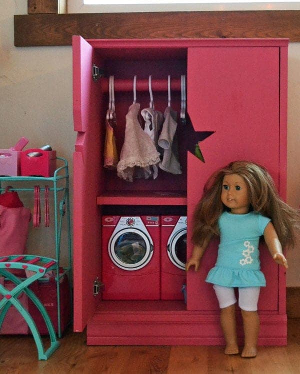 Small wooden doll closet with doors, a hanging rod, and a cut-out star