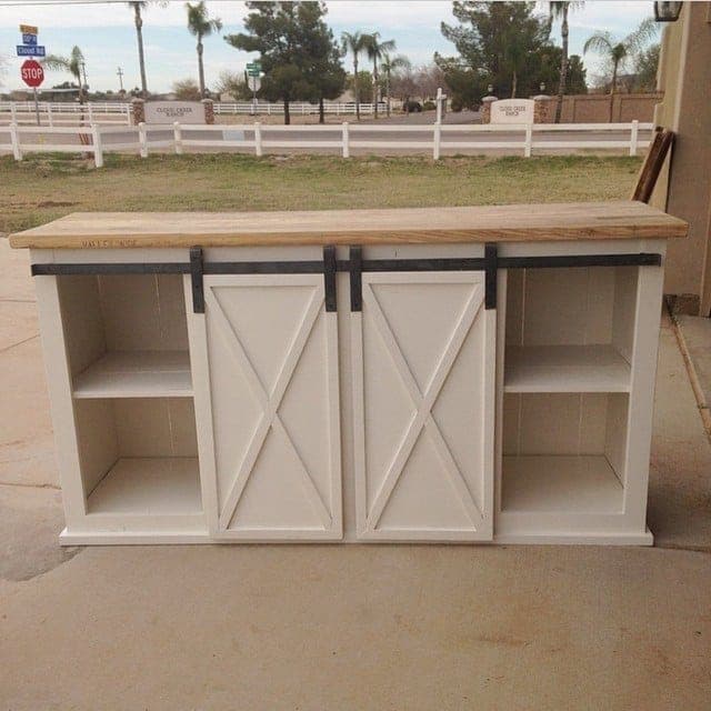 Long farmhouse media console with sliding barn doors and planked back