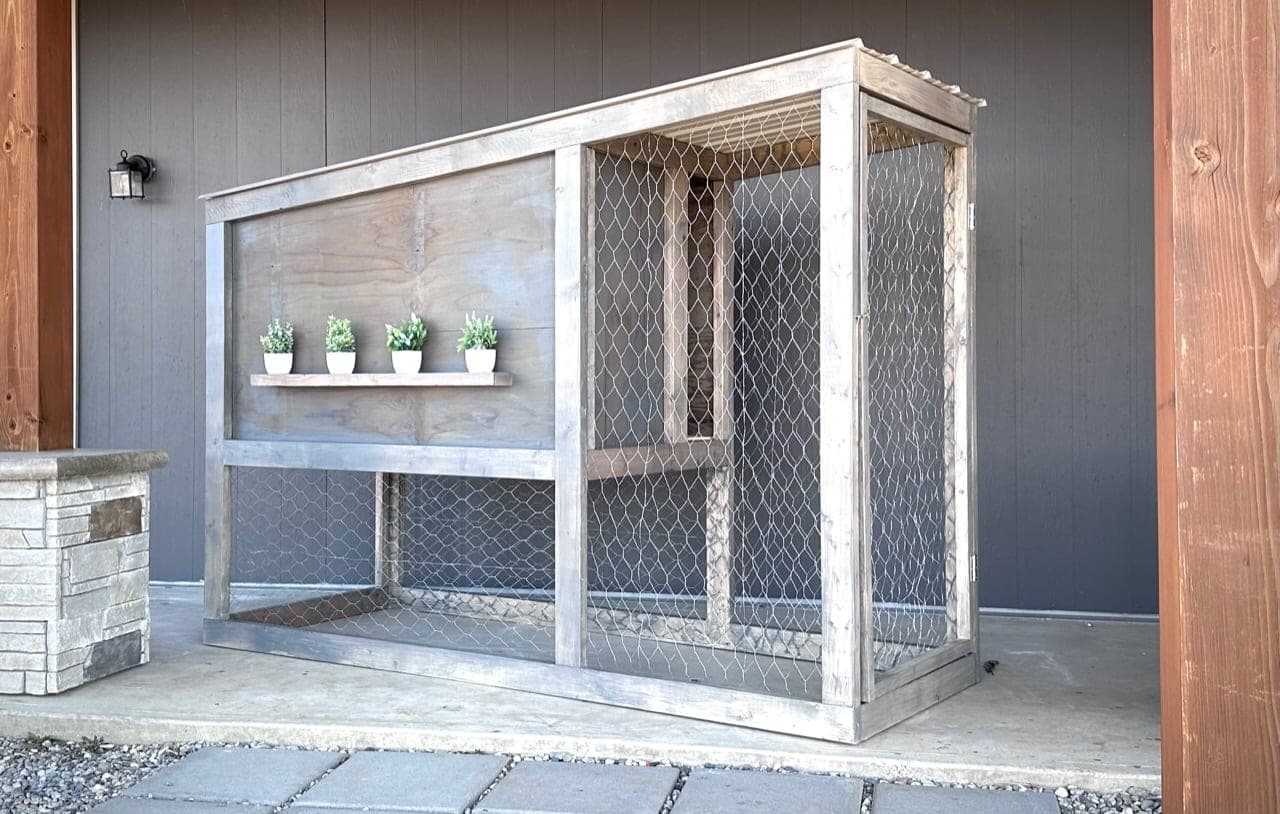 Small modern chicken coop with slanted tin roof and cedar picket siding