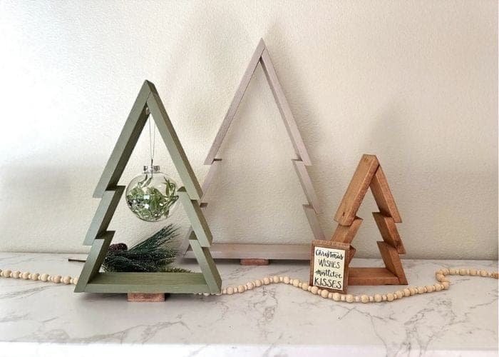 A set of three stylized wood Christmas trees in graduated sizes