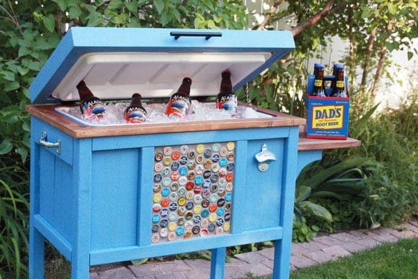 Wood cooler stand with a slatted front, hinged mitered lid, and lower shelf